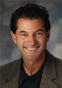 A person smiling for the camera Description automatically generated with medium confidence