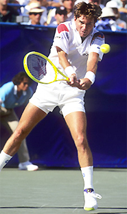 A person hitting a ball with a tennis racket Description automatically generated