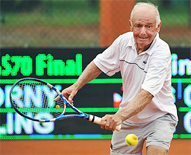 A person hitting a ball with a tennis racket Description automatically generated