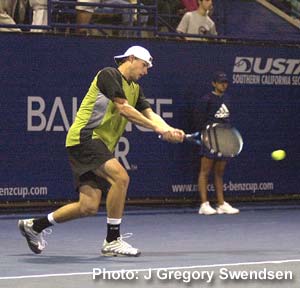 A person hitting a ball with a tennis racket Description automatically generated