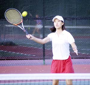 A person hitting a ball with the tennis racket Description automatically generated